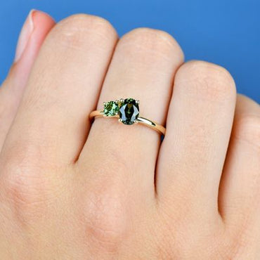 1.05ct Oval + 0.34ct Round Green Sapphire Ring 9kt YG