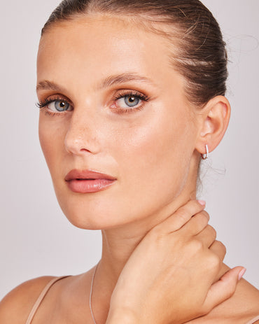 Model wearing 0.10ct Lab Grown Diamond Hoop Earrings in 9K White Gold