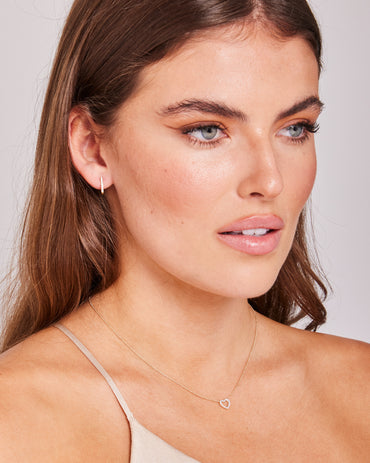Model wearing 0.1ct Lab Grown Diamond Heart Necklace in 9K Yellow Gold